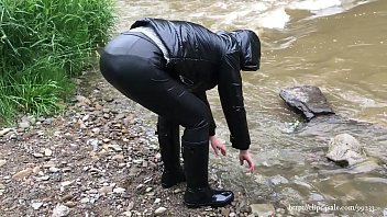 Milf walk outdoors in letaher leggings, shiny jacket and rubber boots